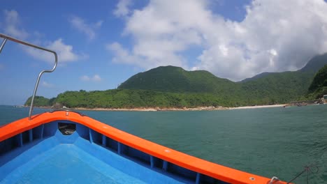 cruising on a bumpy boat in a sea along the coast of breathtaking mountains