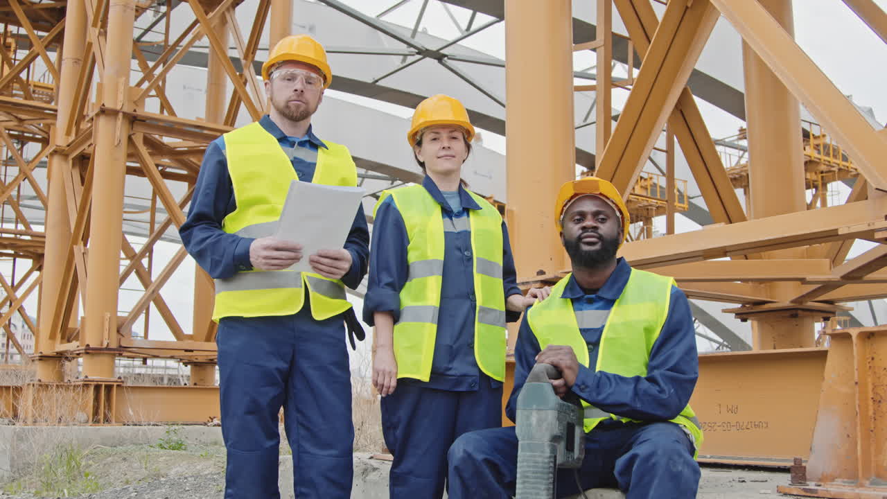 Portrait of Construction Workers Standing Beside Scaffolding