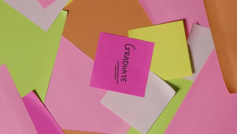 education concept of revolving sticky notes with graduate written on top note