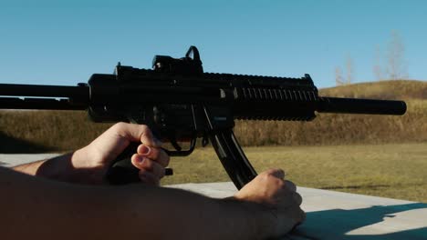 reloading gun, changing mags, ammo switch on sig mpx k suppressed karabin gsg 15 black sunny blue sky shooting range