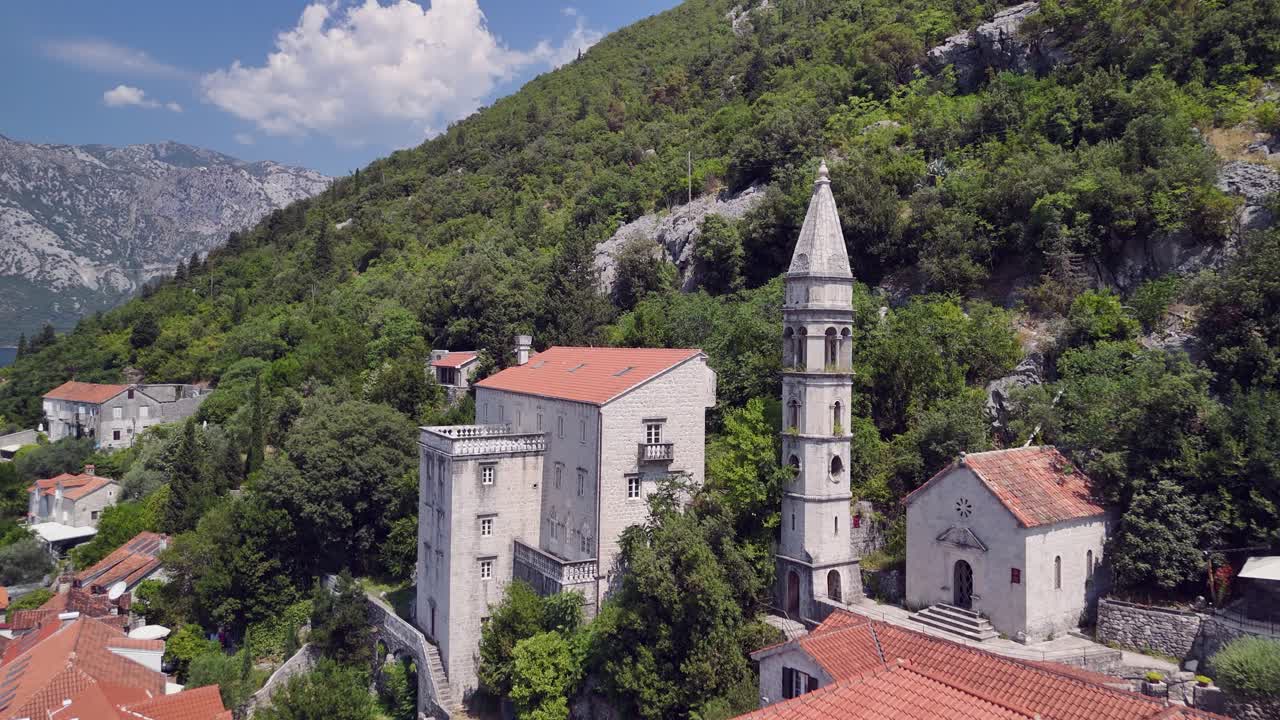 Flyover quaint hillside coastal town rooftops of Perast, Montenegro