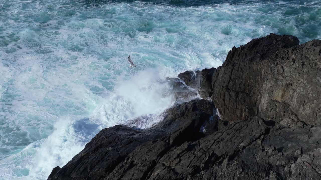Foamy Waves On The Rocky Shoreline Of Seixo Branco Beach Near Oleiros In Galicia, Spain. Slow Motion Shot
