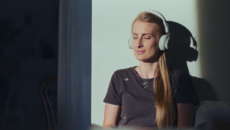 woman listens to music on headphones with pleasure and is happy