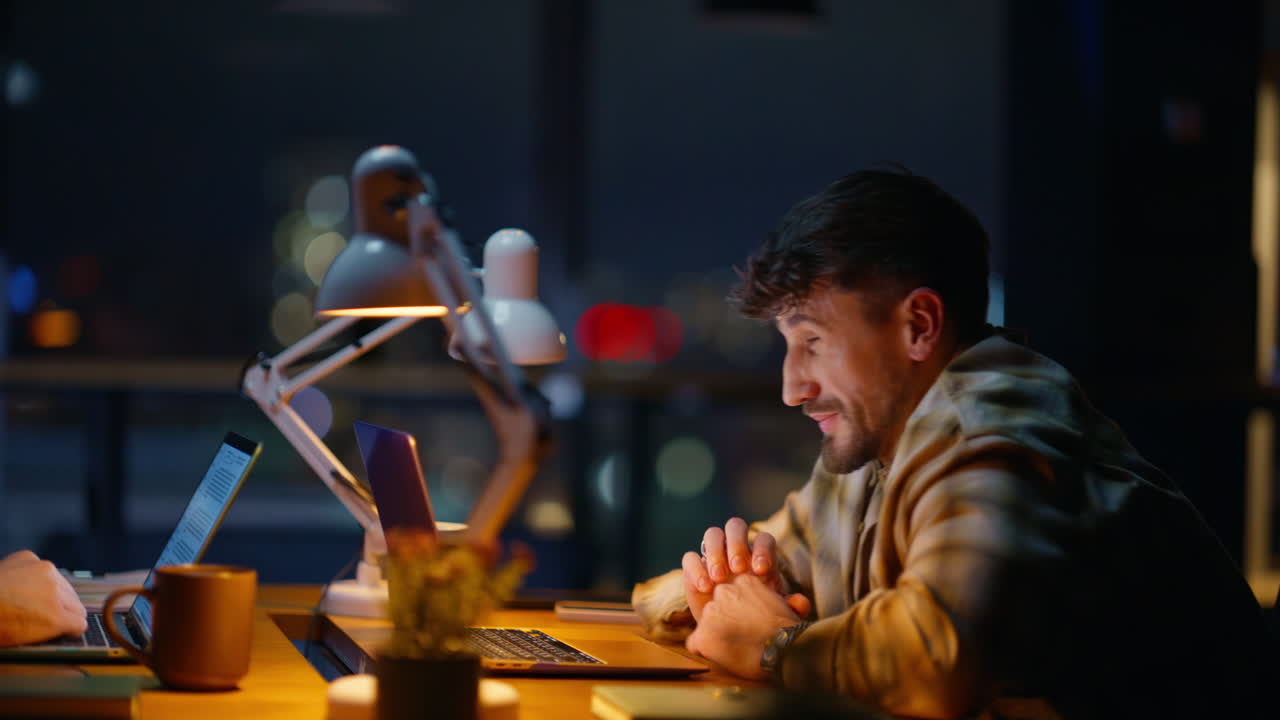 Overworked late worker yawning texting computer indoors closeup. Overtime job