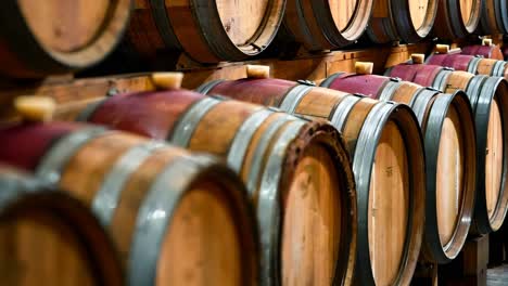 a bunch of wooden wine barrels stacked on top of each other