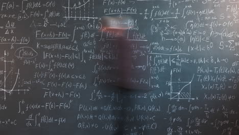 professor in front of a blackboard full of equations