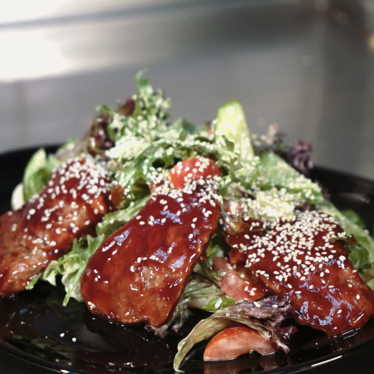 Chef is working on the presentation of the dish. Salad is decorated with sesame seeds. Sqare video