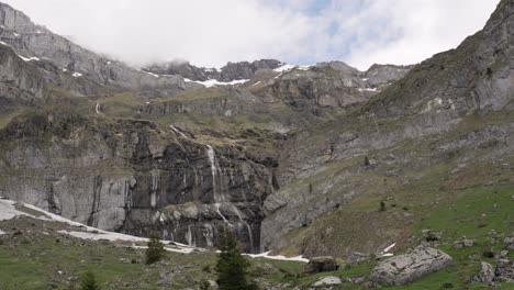 impressive mountain range with multiple waterfalls in switzerland