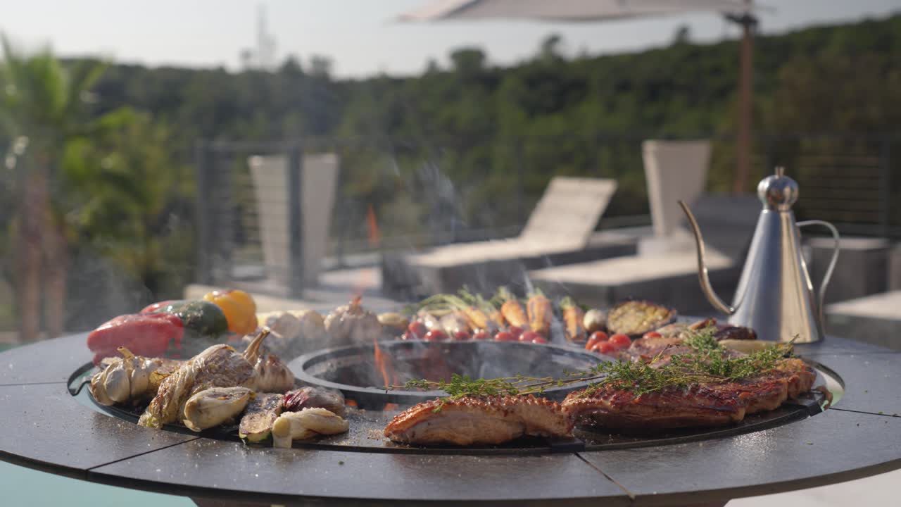 establishing shot of thyme cooking ontop of steak with vegetables on a BBQ
