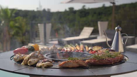 establishing shot of thyme cooking ontop of steak with vegetables on a bbq