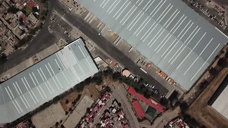 aerial drone shot over the edge of a neighborhood and industrial warehouse area in cuautitlan izcalli, mexico