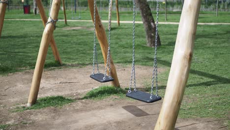 wooden swing set in a park