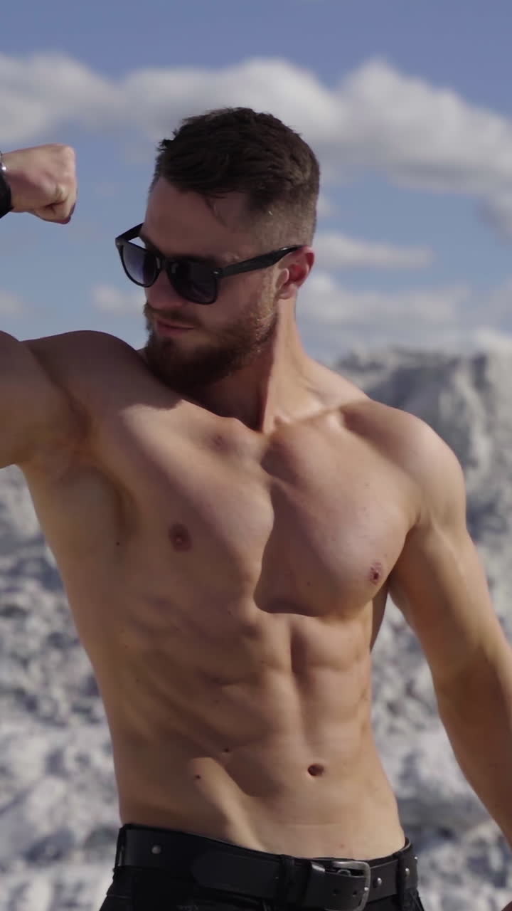 Muscular man posing outdoors. Handsome muscular shirtless hunk man outdoor