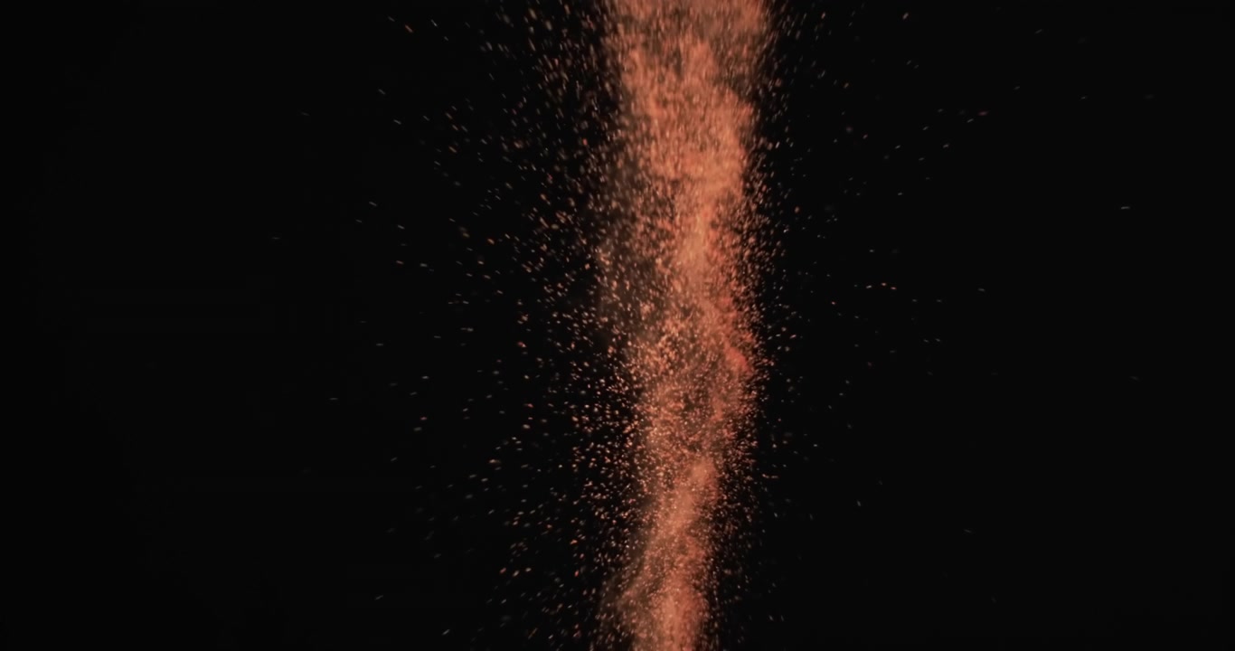 Video di granelli di sabbia lanciati in aria e spazio per il testo su sfondo nero.