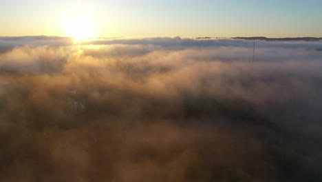 sunrise through foggy mountains