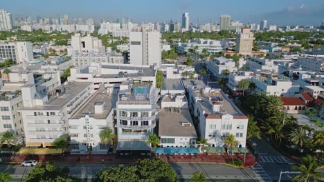 Drone-tracking-shot-along-Ocean-Drive,-Miami-beach-displaying-iconic-Art-Deco-buildings-and-hotels