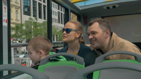 family with child traveling around vienna by double-decker bus