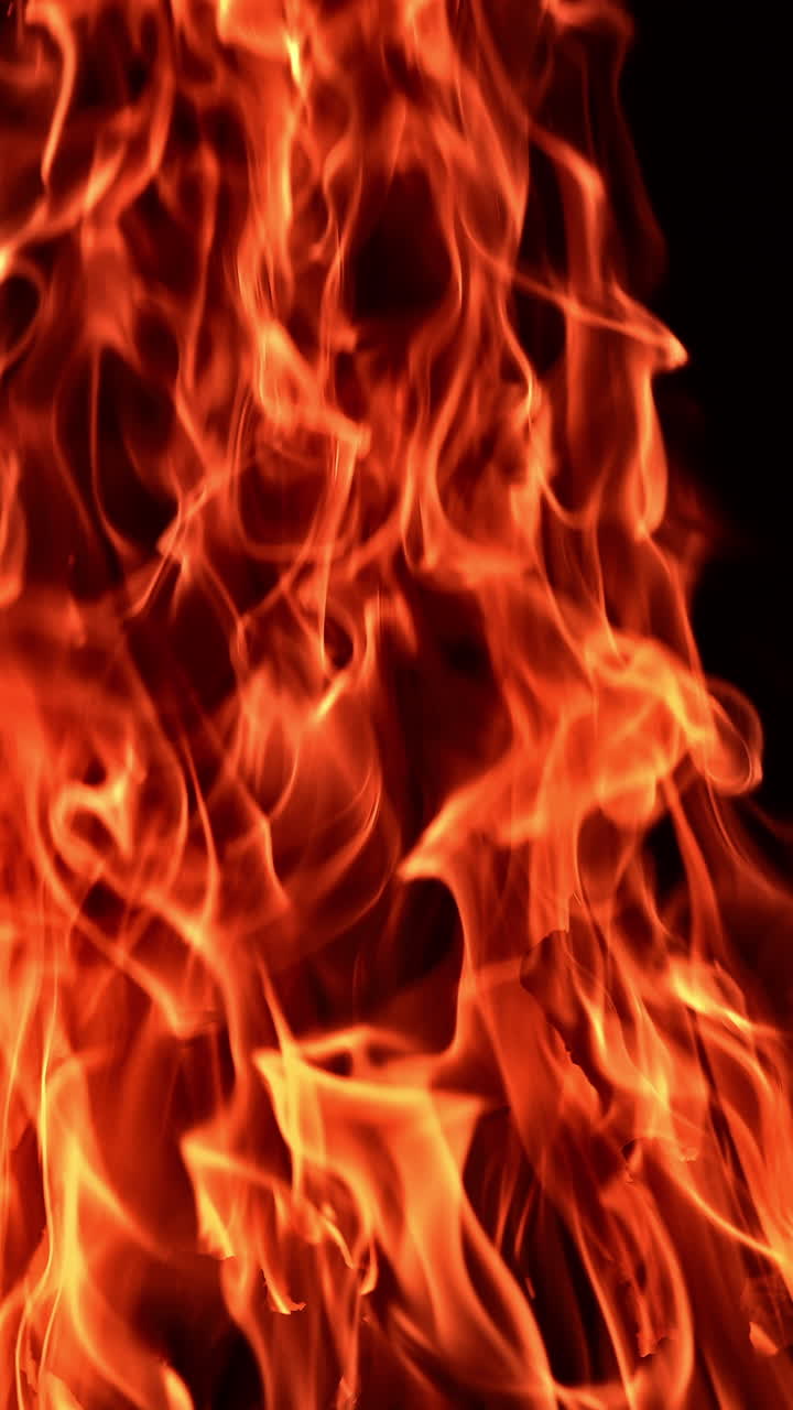 A fire pit with burning flame. Campfire flame glowing on dark background.