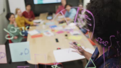 Happy-diverse-business-people-discussing-work-during-meeting-at-office