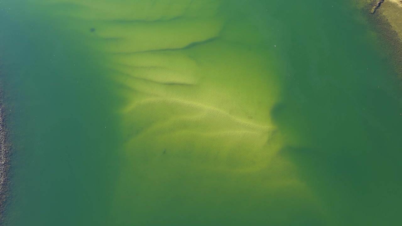 Aerial View of Clear Green Water and Sandy Shoreline