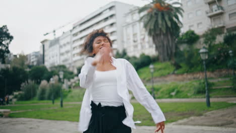 energetic emotional dancer moving body performing hiphop at park. woman dancing