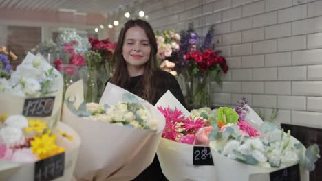 beautiful and charming flower arrangement with happy smiling florist in flower shop