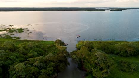 drone shot flying over parana river in sunset time