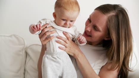 Positive-mom-training-to-walk-and-kissing-cute-baby