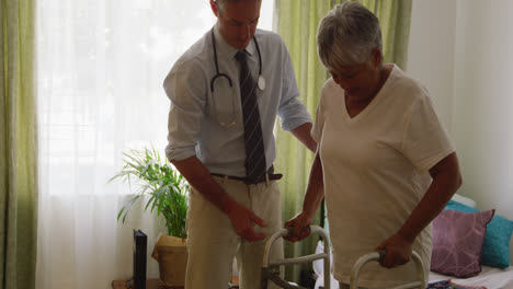 Doctor-helping-senior-woman-in-her-room-of-retirement-house