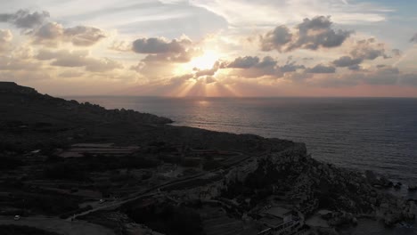 Aerial-drone-video-from-north-of-Malta,-Cirkewwa,-showing-the-beautiful-landscape-over-Paradise-Bay-during-sunset