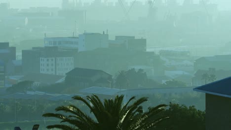 General-view-of-cityscape-with-multiple-modern-buildings-and-shipyard-covered-in-smog