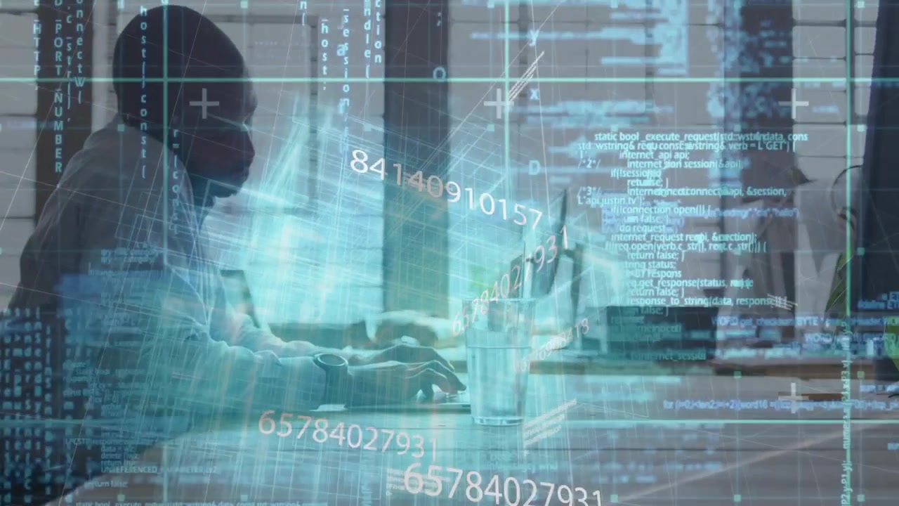 Developer typing at monitor and launching hologram code streams across office table for data review