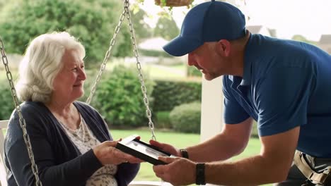heartwarming interaction: a joyful surprise revealed between a smiling elderly woman and a visitor on a cherished swing in a serene outdoor setting