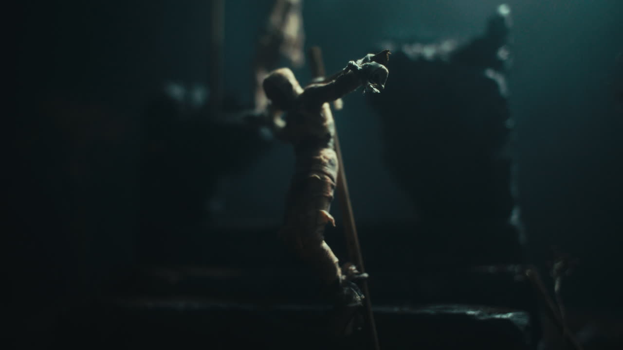 Miniature mummified dolls hanging on the gallows at night