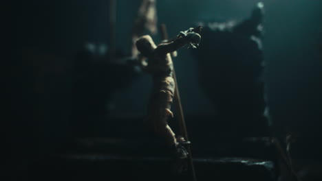 miniature mummified dolls hanging on the gallows at night