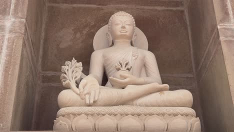 closeup of a stone buddha statue at the buddhist temple carved from a single block of stone