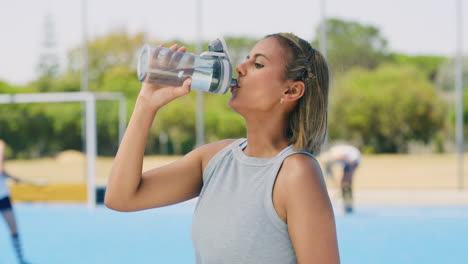 mixed race hockey player drinking water