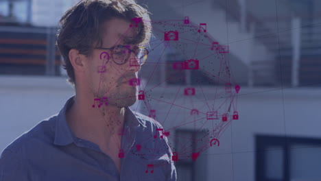 man wearing glasses viewing cybersecurity overlay on balcony, showing padlock and envelope icons