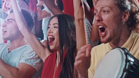 group of fans cheering for sports team