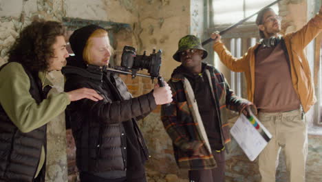 equipo de producción y camarógrafo grabando una escena en un edificio en ruinas 1