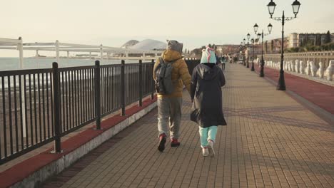 couple walking on a beachfront path