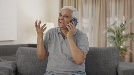 Happy-Indian-old-man-talking-on-phone