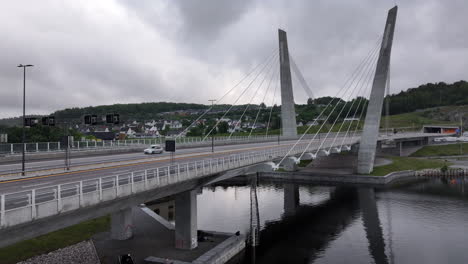 aerial view of cars driving through the bridge over the farris lake in larvik, norway