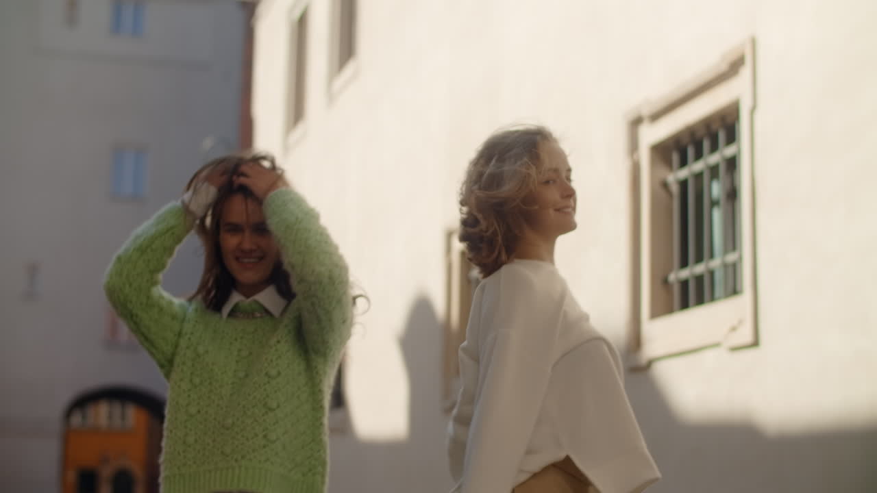 Two Young Women Dancing in a City Street