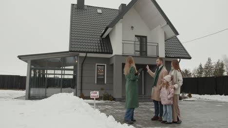 real estate agent showing house to family