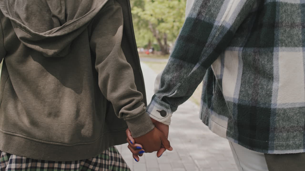 Mother and Son Holding Hands at Walk Outdoors