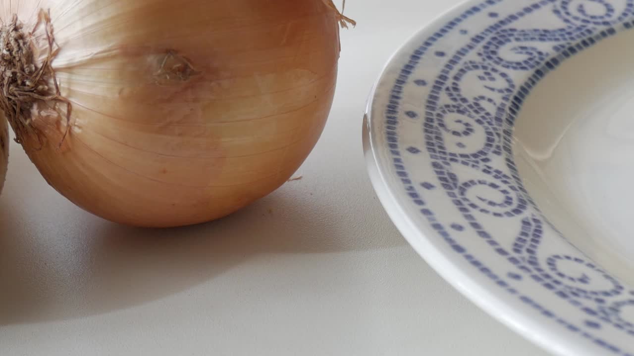 Fresh potato, onion, and plate, ingredients for making Spanish Potato Omelette