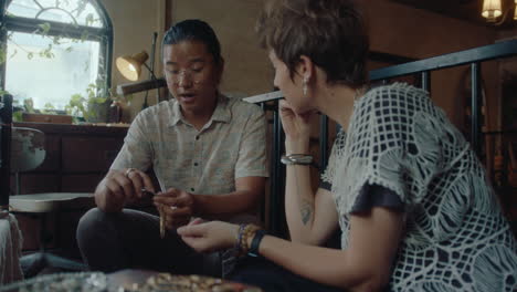 antiques dealer telling about item to female customer