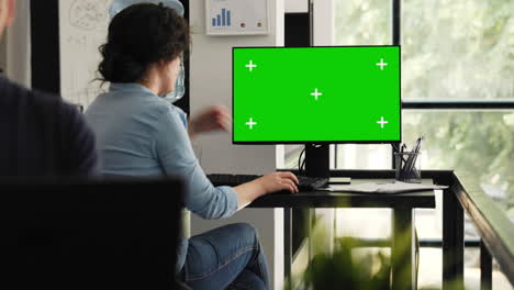 businesswoman examining greenscreen