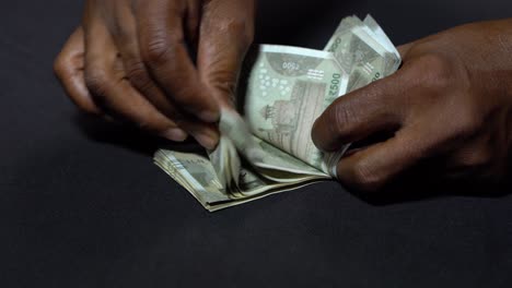 a man counting indian rupees